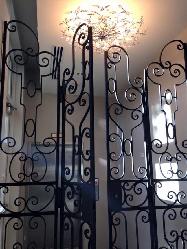 Custom iron gates leading from the Wine Room to the rooftop elevators at Grand Bohemian Hotel Charleston.